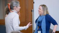 two faculty members talking